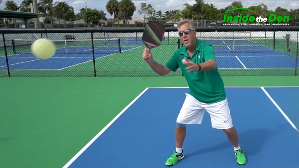 pickleball player pulling paddle back to hit a swing volley
