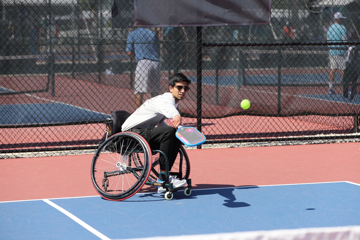 Wheelchair pickleball athlete returning a shot during a match at the US Open Pickleball Championships in Naples, Florida