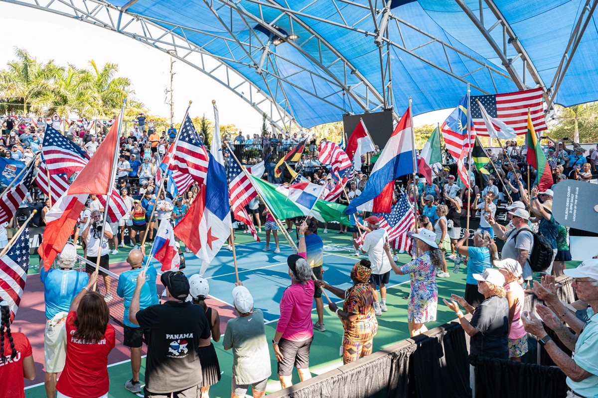 Players and fans gather on Championship Court for the US Open flag ceremony at the US Open Pickleball Championships, celebrating participants from 50 countries and all 50 states.